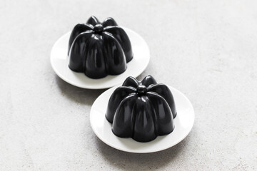 Black Matcha Cream Pudding on a plate. Close-up	