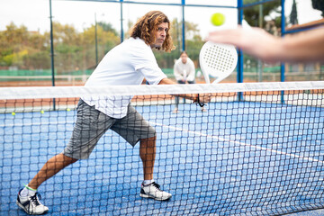 Man training to play tennis on the padel court outdoor