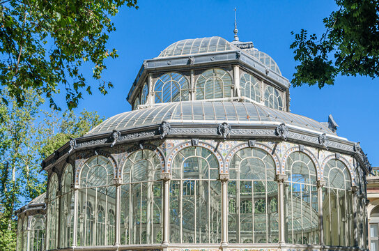 MADRID, SPAIN - AUGUST 18, 2021: Palacio de Cristal ("Glass Palace"), in Madrid, Spain, built in 1887 for the Philippines Exposition. Currently it belongs to the Reina Sofia Museum