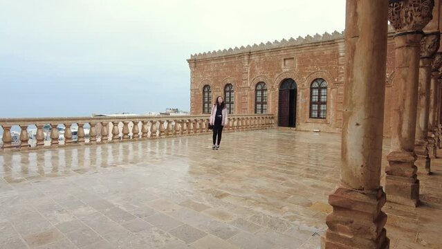 It is the upper floor courtyard of the cut stone building used as the Mardin Archeology Museum. Seen on a tourist camera. It's winter time and rainy weather.