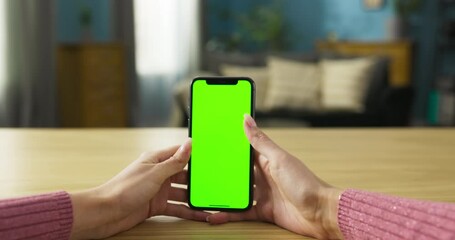 Music lover, browsing through a music streaming app, creating playlists, or discovering new artists. Her occasional head nods or tapping her fingers to the rhythm indicate her enjoyment of the music.