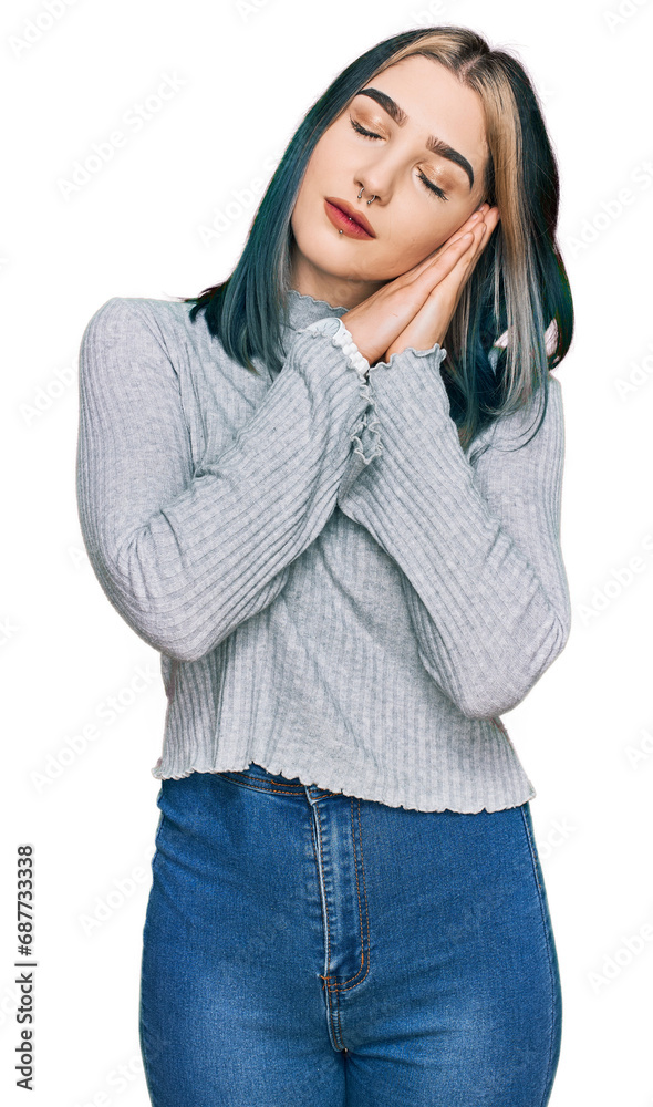 Wall mural Young modern girl wearing casual sweater sleeping tired dreaming and posing with hands together while smiling with closed eyes.