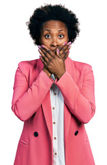 African american woman with afro hair wearing business jacket shocked covering mouth with hands for mistake. secret concept.