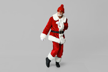 Cool Santa Claus in sunglasses on grey background