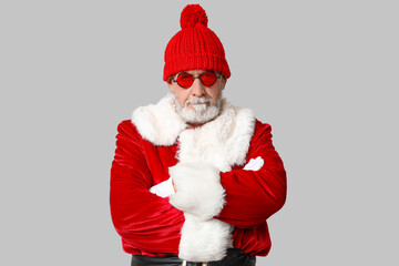 Cool Santa Claus in sunglasses on grey background