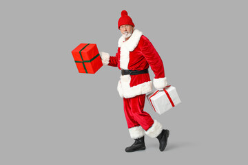 Cool Santa Claus with gift boxes on grey background
