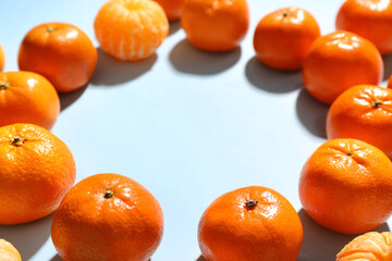 Frame made of sweet mandarins on blue background