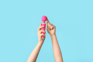 Female hands with pink vibrator on color background, closeup - obrazy, fototapety, plakaty