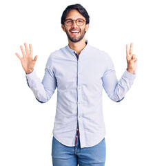 Handsome hispanic man wearing business shirt and glasses showing and pointing up with fingers number seven while smiling confident and happy.