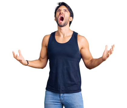 Handsome hispanic man wearing casual clothes crazy and mad shouting and yelling with aggressive expression and arms raised. frustration concept.