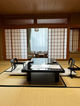 Kanazawa, Japan - 05.11.2023. Traditional Ryokan room. Ryokan Japanese Inn Traditional room Interior with two chairs and table on the tatami floor Asia Travel
