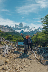 two girls posing, fitroy mountain in the back - obrazy, fototapety, plakaty
