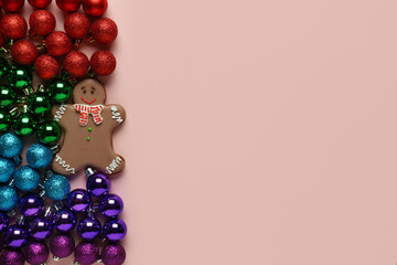 Naklejka na ściany i meble Gingerbread cookie with Christmas tree balls on beige background