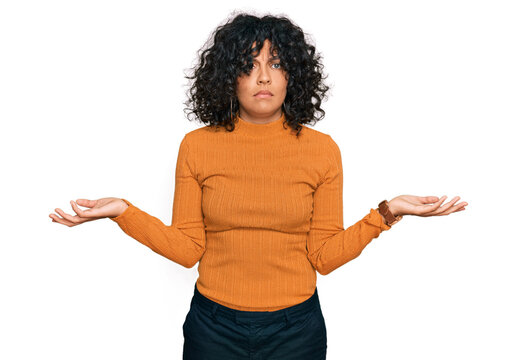 Young hispanic woman wearing casual clothes clueless and confused with open arms, no idea concept.