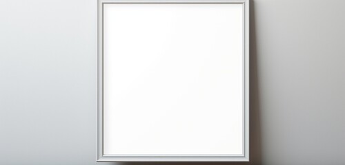 An empty picture frame subtly casts its shadow on a plain background, offering a simple and versatile canvas.