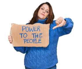 Young plus size woman holding power to the people banner with angry face, negative sign showing dislike with thumbs down, rejection concept