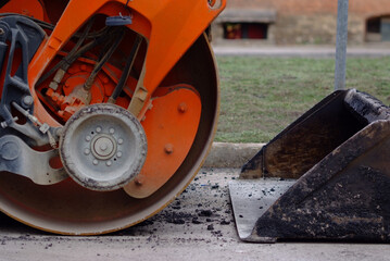 road roller and construction bucket closeup