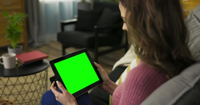 Woman avid online shopper, exploring various e-commerce websites and adding items to her virtual cart. The green mockup screen represents the endless possibilities of products she can choose from.