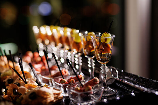 Variety of appetizers and snacks in small glasses at the event