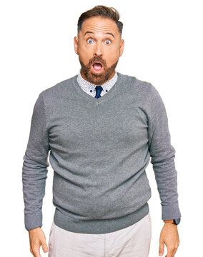 Handsome middle age man wearing business clothes afraid and shocked with surprise and amazed expression, fear and excited face.