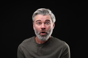 Personality concept. Portrait of emotional man on black background