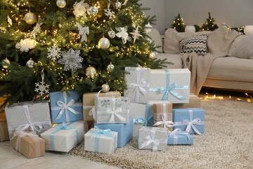 Many gift boxes under decorated Christmas tree in room