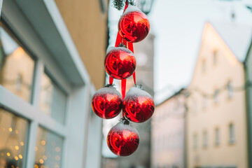 Christmas Red balls in the snow .Soft focus.Christmas street decor in a European city. Winter holidays in Europe