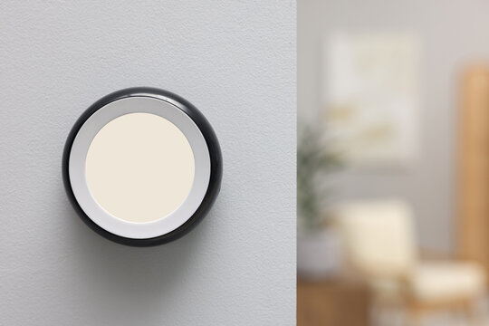 One thermostat on white wall indoors, space for text. Smart home system
