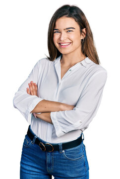 Young caucasian girl wearing casual white shirt happy face smiling with crossed arms looking at the camera. positive person.