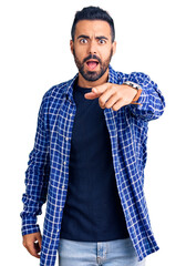 Young hispanic man wearing casual clothes pointing displeased and frustrated to the camera, angry and furious with you
