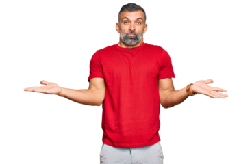 Middle age handsome man wearing casual clothes clueless and confused expression with arms and hands raised. doubt concept.