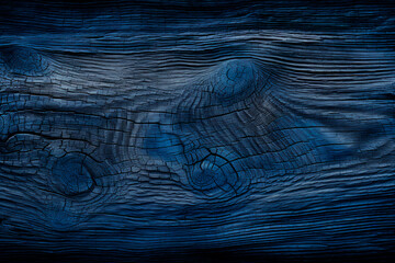 Fototapeta premium A background featuring weathered, old wood with shades of blue and black. 