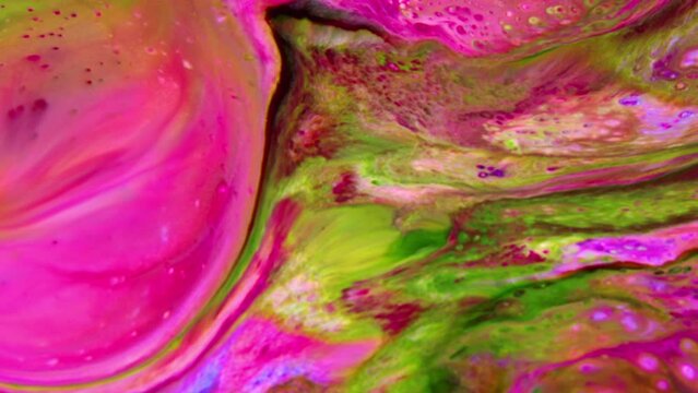 Close-up shot of multi-colored paint mixture boiling in a mixer. They form a unique abstraction that can be used in many video projects, as a background or as a compositing element.