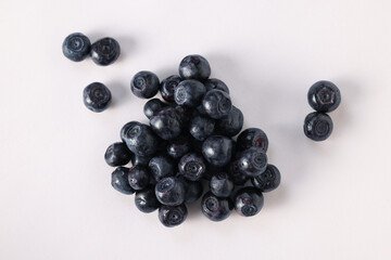 Pile of ripe bilberries on white background, flat lay