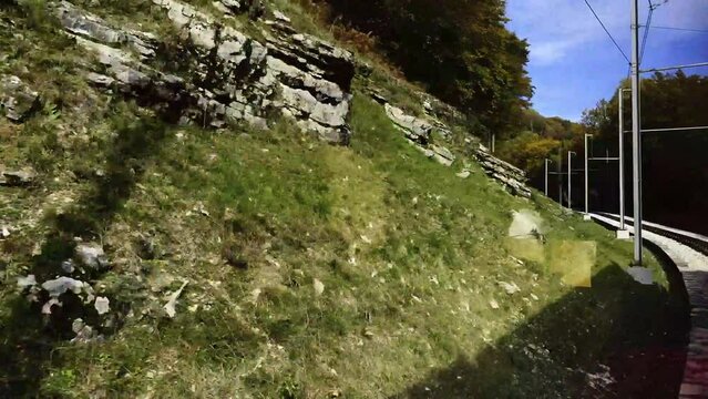 Mountain Train with Window View on Railroad Tracks in the Forest in a Sunny Day in Monte Generoso, Ticino, Switzerland. (Time Lapse)
