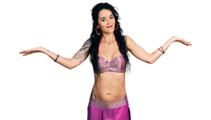 Young indian woman wearing belly dancer costume clueless and confused expression with arms and hands raised. doubt concept.