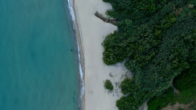 Drone top aerial view of Solanas beach with turquoise water, camper vans and mountain landscape in Sardinia, Italy