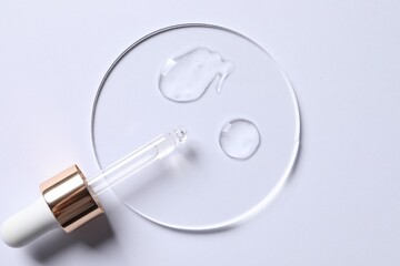 Samples of cosmetic serum and pipette on white background, top view