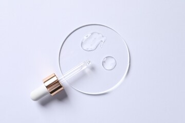 Samples of cosmetic serum and pipette on white background, top view