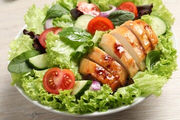 Delicious salad with chicken and vegetables on table, closeup