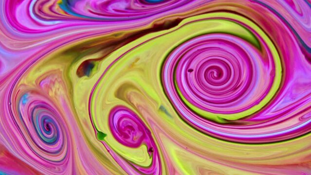 Close-up shot of multi-colored paint mixture boiling in a mixer. They form a unique abstraction that can be used in many video projects, as a background or as a compositing element.