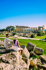 A couple of men and woman visit the Greek temples at Selinunte Sicily during vacation, View on the...
