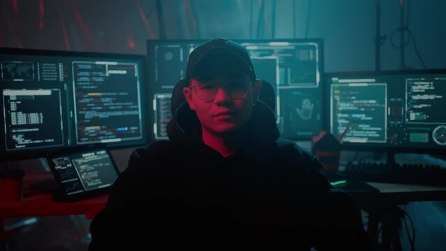 Man sitting in chair and looking at camera during cybercrime