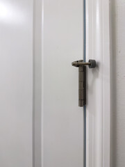 This door stopper mounts on the hinge pin of the door