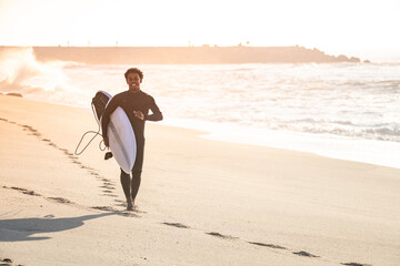 Man surfer run in the beach