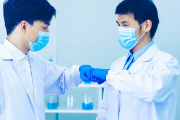 Two asian scientist men fist bump team partner shake hands together. Teamwork Men science chemistry...
