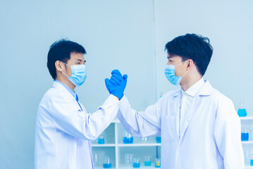 Two asian scientist men team high five partner shake hands together. Science Men research chemistry...