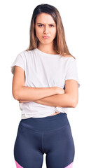 Young beautiful girl wearing casual t shirt skeptic and nervous, disapproving expression on face with crossed arms. negative person.
