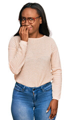 Fototapeta premium Young black woman wearing casual clothes and glasses looking stressed and nervous with hands on mouth biting nails. anxiety problem.