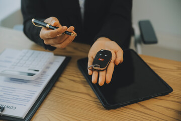 Salesman send key to customer after good deal agreement, successful car loan contract buying or selling new vehicle.